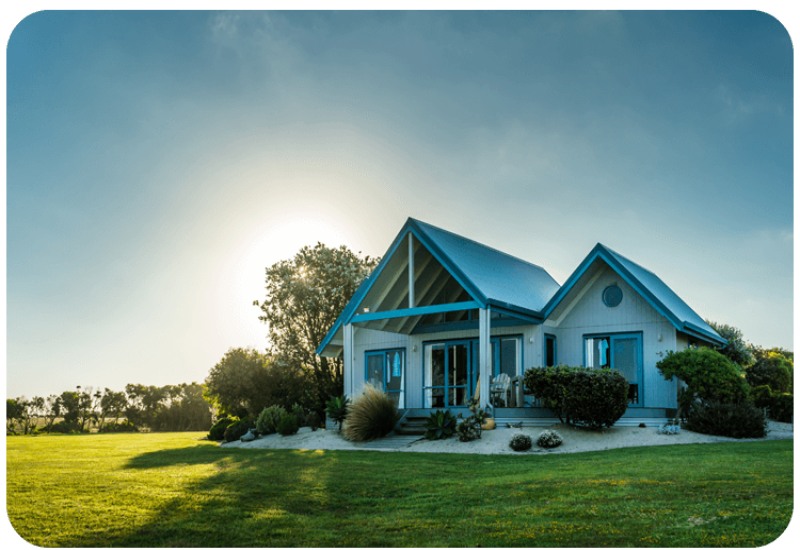 Beautiful home with blue roof and sunset lighting, ideal for residential security in Austin & Dallas, TX