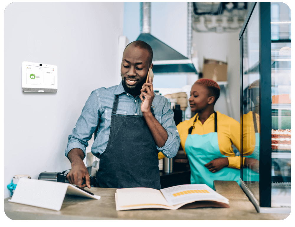 A digital home security panel positioned on a light-colored wall in a café in Phoenix, AZ.