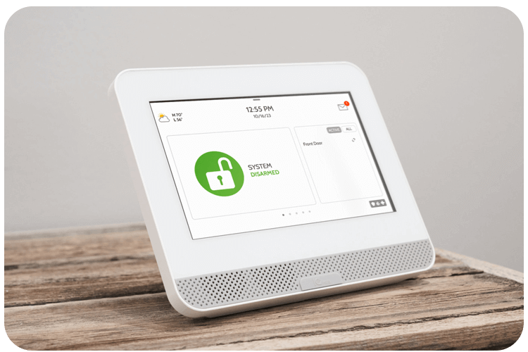 A home security panel is placed on a surface displaying a system disarmed status in Phoenix, AZ.