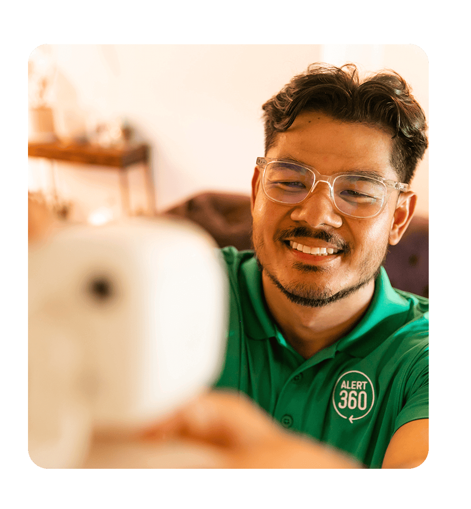 A man is installing a camera inside a house in Austin and Dallas, TX