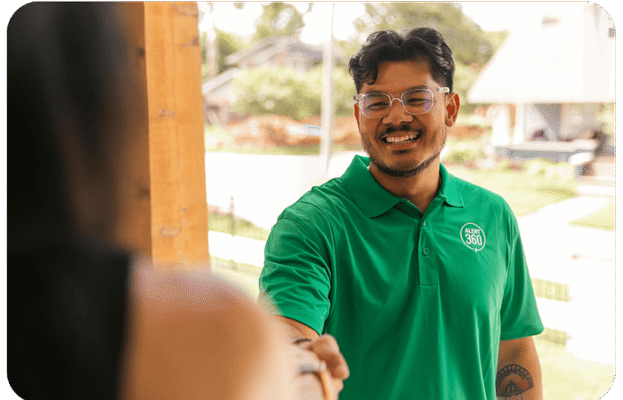 Smiling Alert 360 representative shaking hands with customer