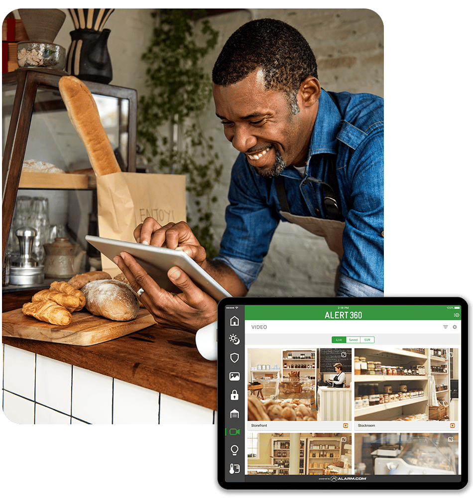 Business owner monitoring video feeds from a tablet